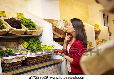 Young person in a fruit stall View Large Photo Image Stock Photo - Young person in a fruit stall. Fotosearch