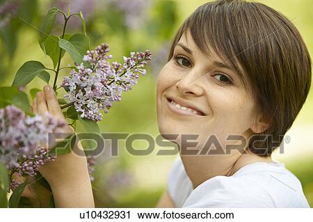 Stock Image - Young person leisurely in a park. Fotosearch