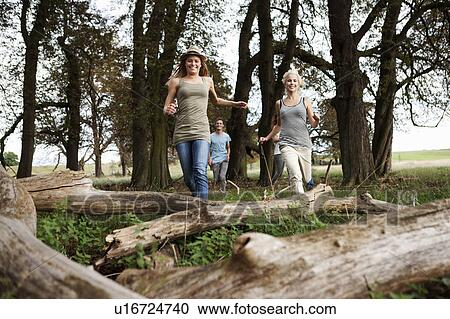 Young persons running in woods View Large Photo Image Stock Image - Young persons running in woods. Fotosearch