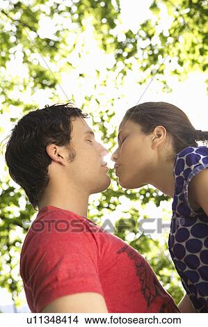 Young romantic couple in a park View Large Photo Image Picture - Young romantic couple in a park. Fotosearch