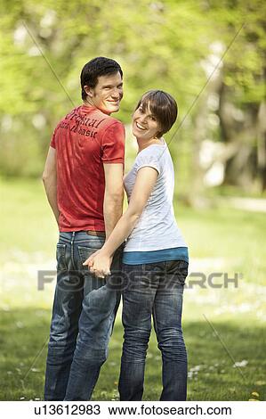 Young romantic couple in a park View Large Photo Image Stock Image - Young romantic couple in a park. Fotosearch