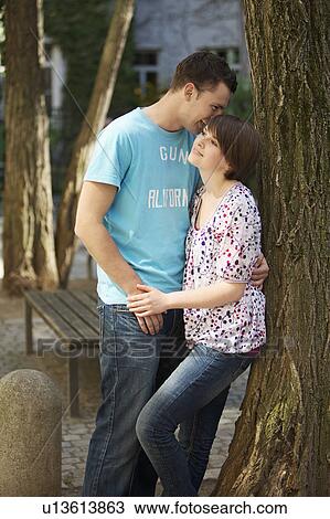Stock Image - Young romantic couple in a park. Fotosearch