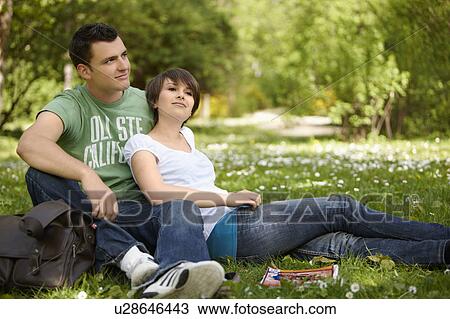 Stock Image - Young romantic couple in a park. Fotosearch