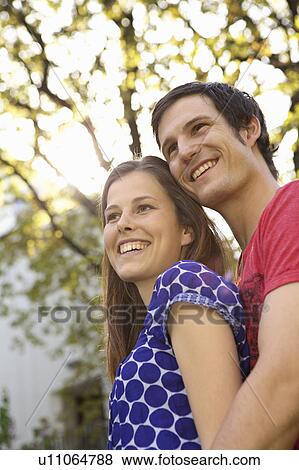Stock Photo - Young romantic couple in a park. Fotosearch
