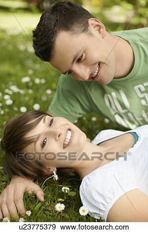 Young romantic couple in a park View Large Photo Image Stock Photo - Young romantic couple in a park. Fotosearch