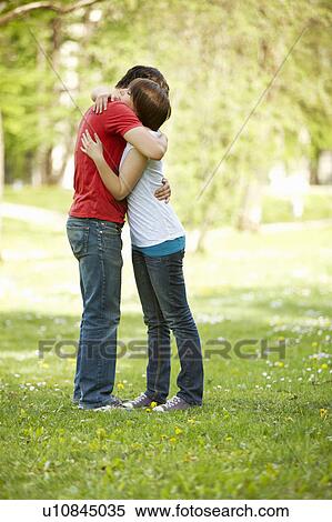 Stock Photography - Young romantic couple in a park. Fotosearch