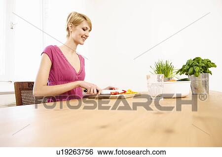 Young Woman at Home Preparing Food View Large Photo Image Stock Photograph - Young Woman at Home Preparing Food. Fotosearch