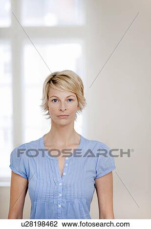 Stock Image - Young woman at home. Fotosearch
