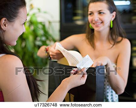 Young woman buying hat View Large Photo Image Stock Photo - Young woman buying hat. Fotosearch