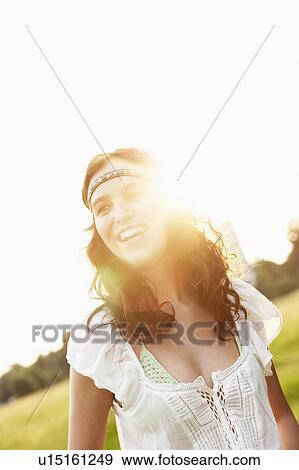 Stock Photo - Young woman by sunset. Fotosearch