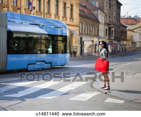 Young woman crossing road View Large Photo Image Stock Image - Young woman crossing road. Fotosearch