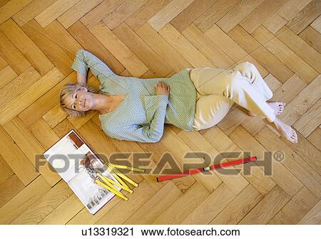 Young woman decorating home View Large Photo Image Stock Image - Young woman decorating home. Fotosearch