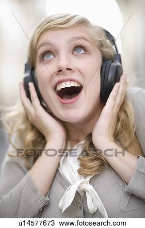 Young woman hearing music View Large Photo Image Stock Image - Young woman hearing music. Fotosearch