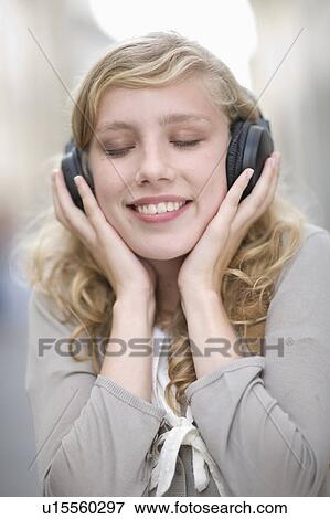 Young woman hearing music View Large Photo Image Stock Photo - Young woman hearing music. Fotosearch