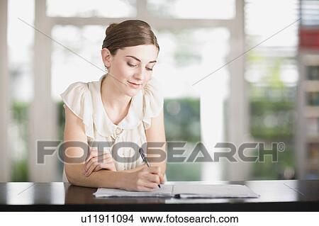 Young woman in an office View Large Photo Image Picture - Young woman in an office. Fotosearch