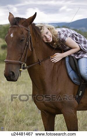 Young woman on a horse View Large Photo Image Stock Photo - Young woman on a horse. Fotosearch