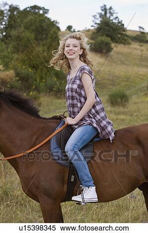 Young woman on a horse View Large Photo Image Stock Photography - Young woman on a horse. Fotosearch