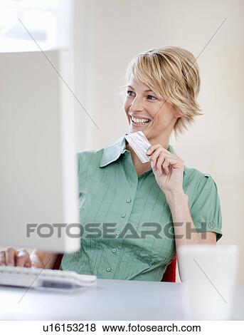 Stock Photo - Young woman online shopping. Fotosearch