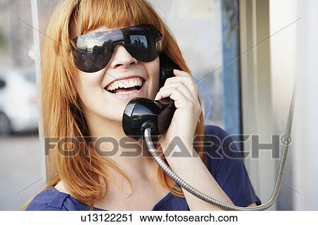 Young woman phoning at call box View Large Photo Image Stock Image - Young woman phoning at call box. Fotosearch