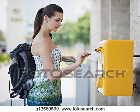 Stock Photo - Young woman posting postcard. Fotosearch