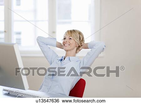 Young woman relaxing at desk View Large Photo Image Stock Photograph - Young woman relaxing at desk. Fotosearch