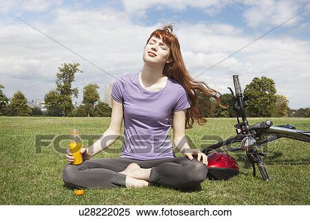 Young woman relaxing from bikeride View Large Photo Image Stock Photography - Young woman relaxing from bikeride. Fotosearch