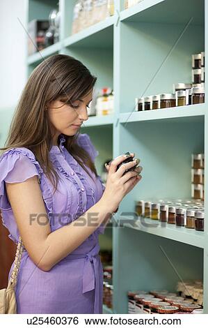 Young woman shopping View Large Photo Image Stock Photograph - Young woman shopping. Fotosearch