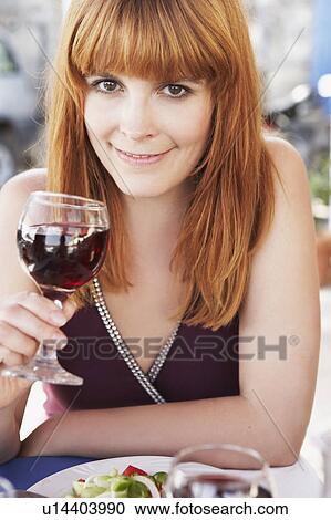 Young woman sipping red wine View Large Photo Image Stock Image - Young woman sipping red wine. Fotosearch