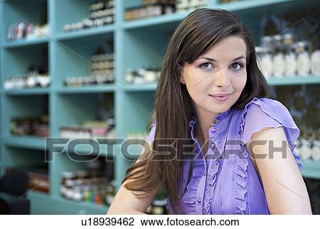 Young woman sitting in cafÈ store View Large Photo Image Stock Image - Young woman sitting in cafÈ store. Fotosearch