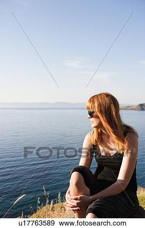 Young woman watching sea View Large Photo Image Stock Photo - Young woman watching sea. Fotosearch