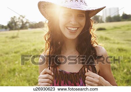 Young woman wearing cowboy hat View Large Photo Image Stock Image - Young woman wearing cowboy hat. Fotosearch