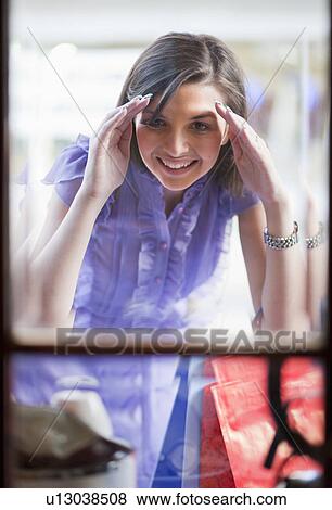 Stock Photo - Young woman window shopping. Fotosearch