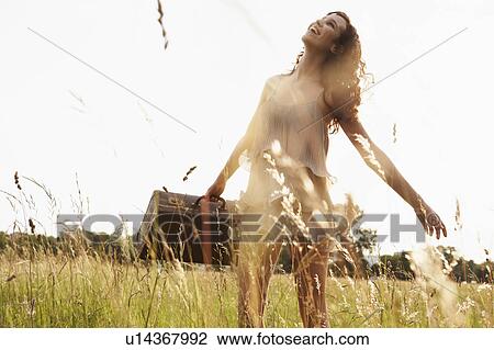 Young woman with case walking in nature View Large Photo Image Stock Image - Young woman with case walking in nature. Fotosearch