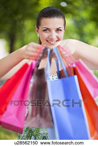 Young woman with shopping bags View Large Photo Image Stock Image - Young woman with shopping bags. Fotosearch