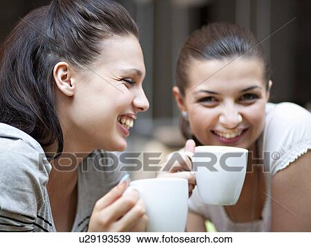 Stock Photo - Young women having coffee. Fotosearch
