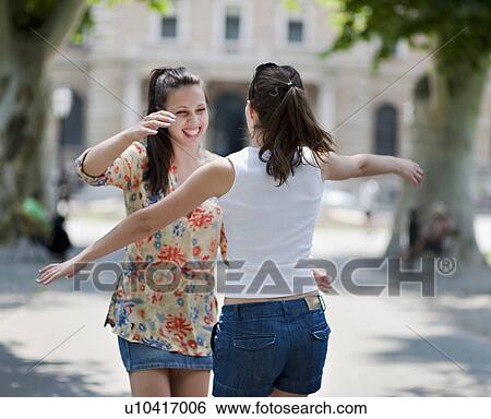 Young women hugging View Large Photo Image Stock Photograph - Young women hugging. Fotosearch