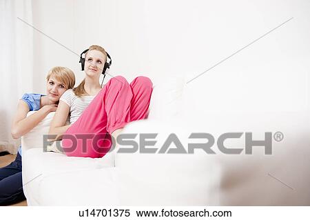 Young women listening to music View Large Photo Image Stock Photography - Young women listening to music. Fotosearch