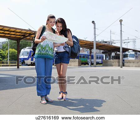 Young women looking at map View Large Photo Image Stock Photo - Young women looking at map. Fotosearch