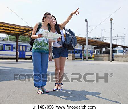 Stock Photograph - Young women looking at map. Fotosearch