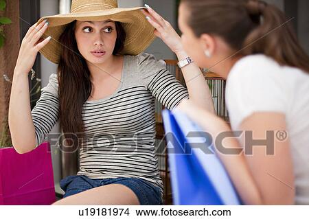 Picture - Young women looking at shopping. Fotosearch