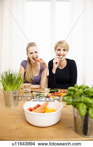 Young Women Preparing Food, eating View Large Photo Image Picture - Young Women Preparing Food, eating. Fotosearch