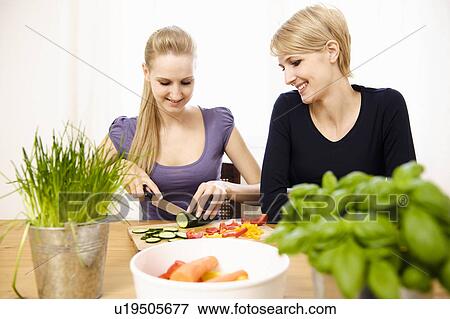 Young Women Preparing Food, eating View Large Photo Image Stock Photo - Young Women Preparing Food, eating. Fotosearch