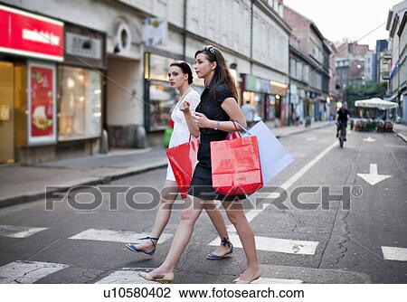 Young women shopping View Large Photo Image Stock Image - Young women shopping. Fotosearch