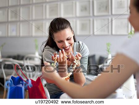 Stock Image - Young women shopping. Fotosearch