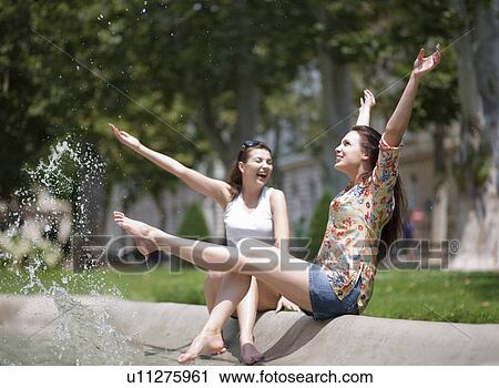 Young women splashing in a fountain View Large Photo Image Stock Image - Young women splashing in a fountain. Fotosearch