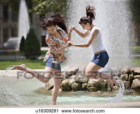 Young women splashing in a fountain View Large Photo Image Stock Image - Young women splashing in a fountain. Fotosearch