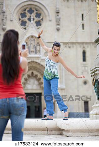 Young women taking photo View Large Photo Image Picture - Young women taking photo. Fotosearch