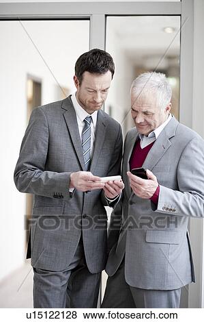 2 businessmen with handhelds View Large Photo Image Stock Photo - 2 businessmen with handhelds. Fotosearch