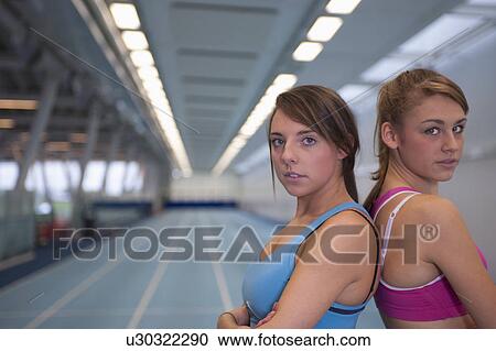 Stock Image - 2 female athletes looking to camera. Fotosearch