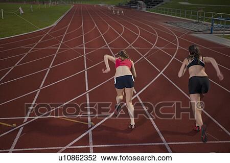 2 female athletes sprinting away View Large Photo Image Stock Image - 2 female athletes sprinting away . Fotosearch